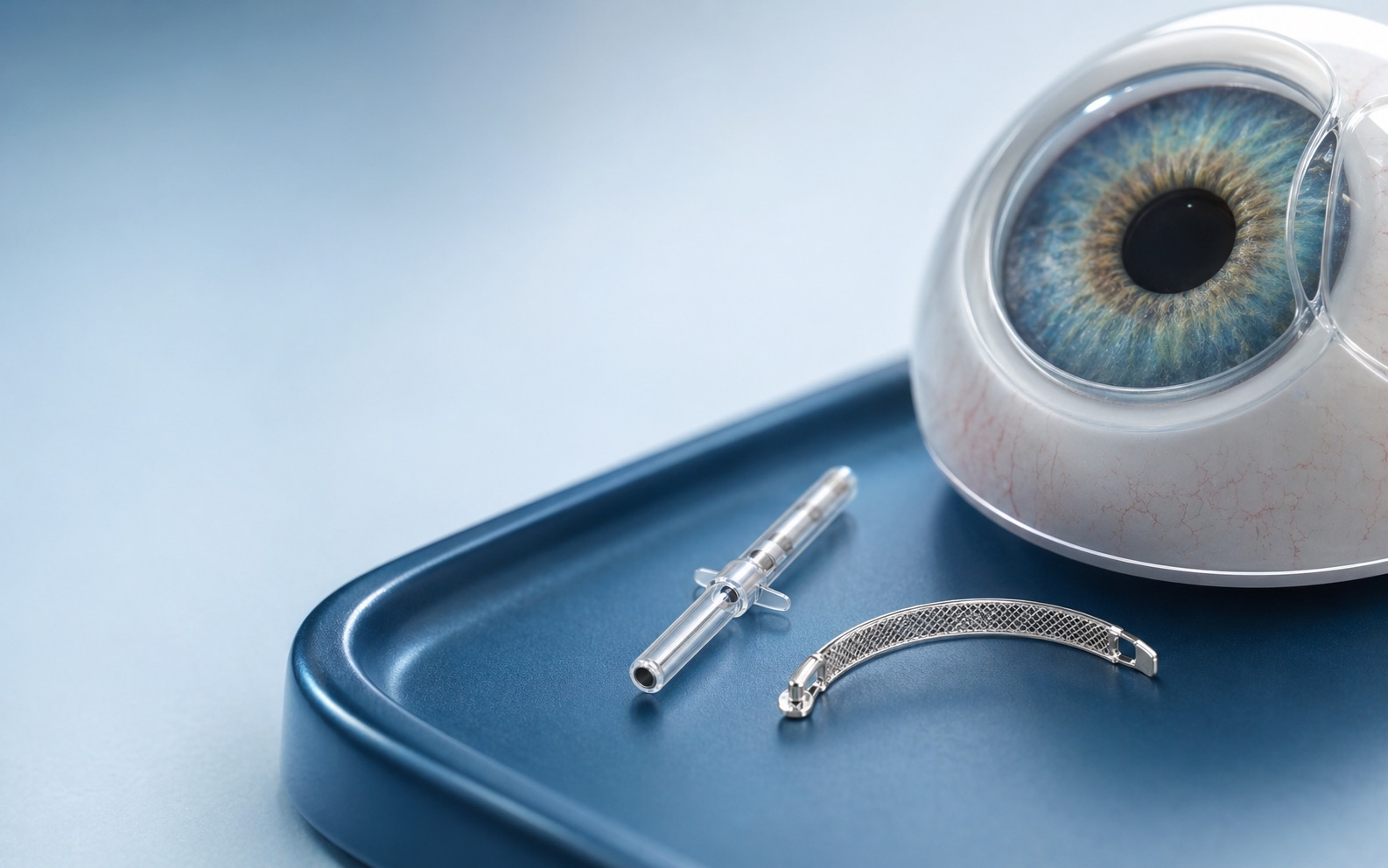 MIGS glaucoma micro-stent implants beside an eye model